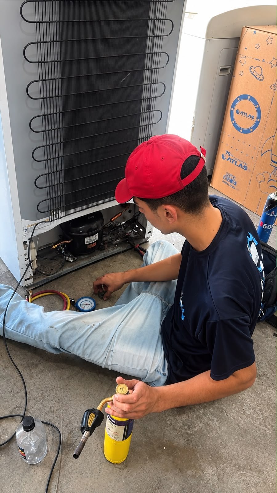 Técnico realizando conserto de geladeira